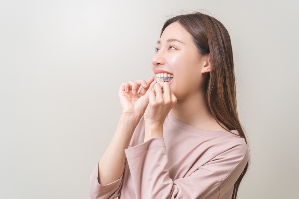 A woman taking out an Invisalign® aligner in Melbourne, FL A woman taking out an Invisalign® aligner in Melbourne, FL