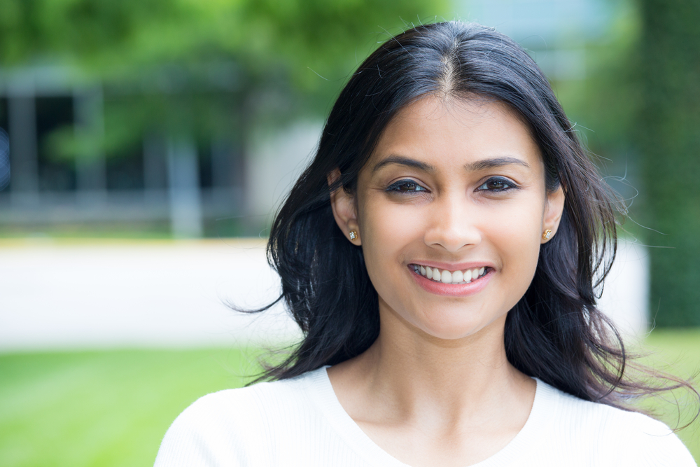 Woman smiling after veneers and teeth whitening in Melbourne, FL