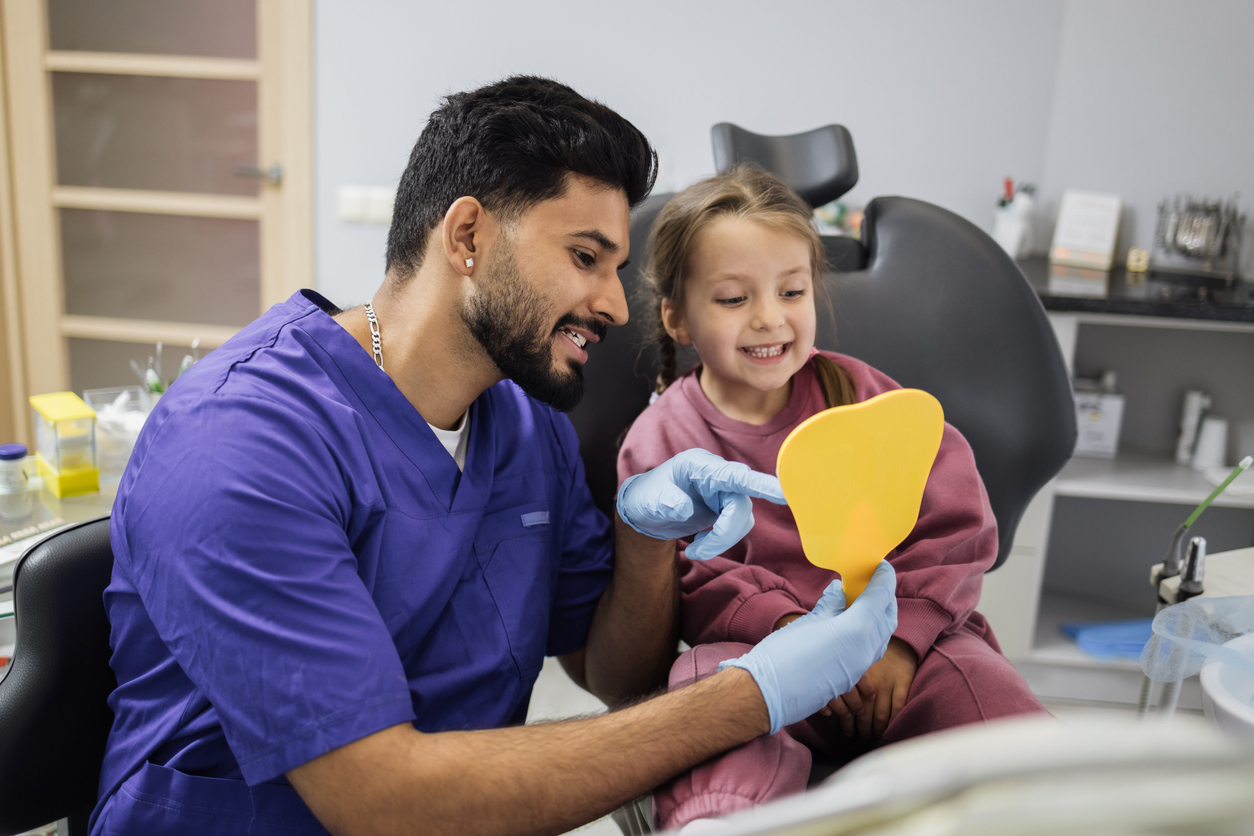 Child smiling after a first dental visit at the dentist